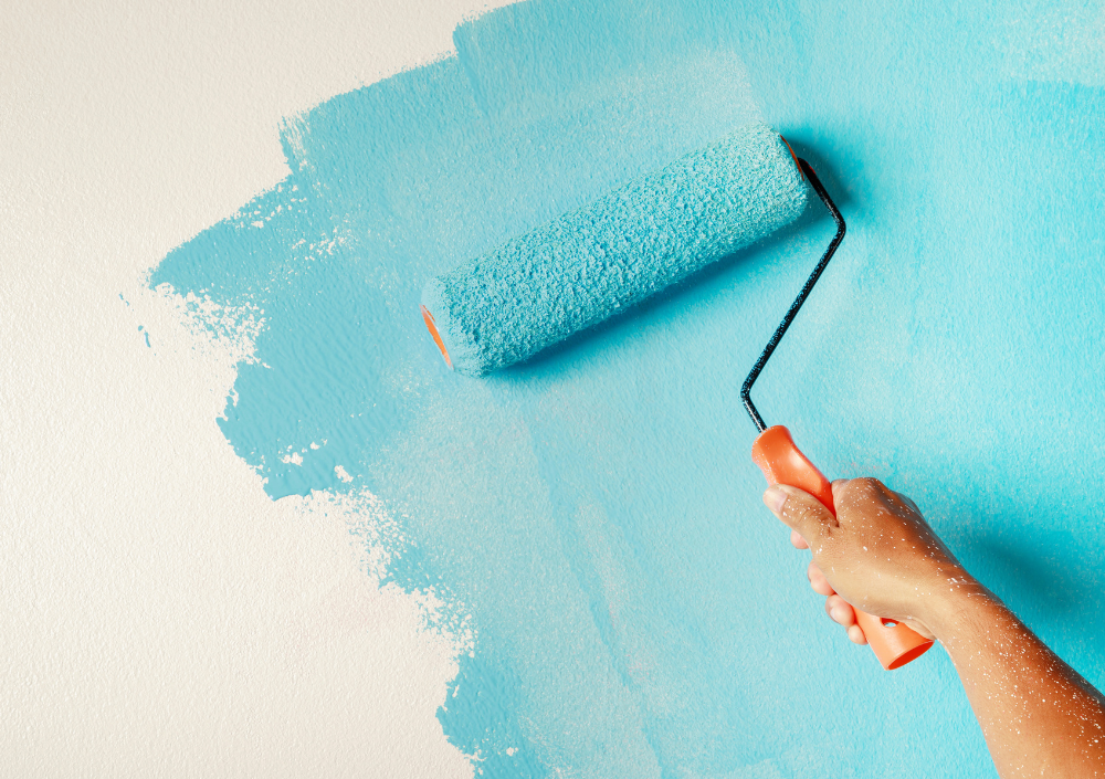 Professional painter rolling paint on a ceiling using specialized rollers and extension poles