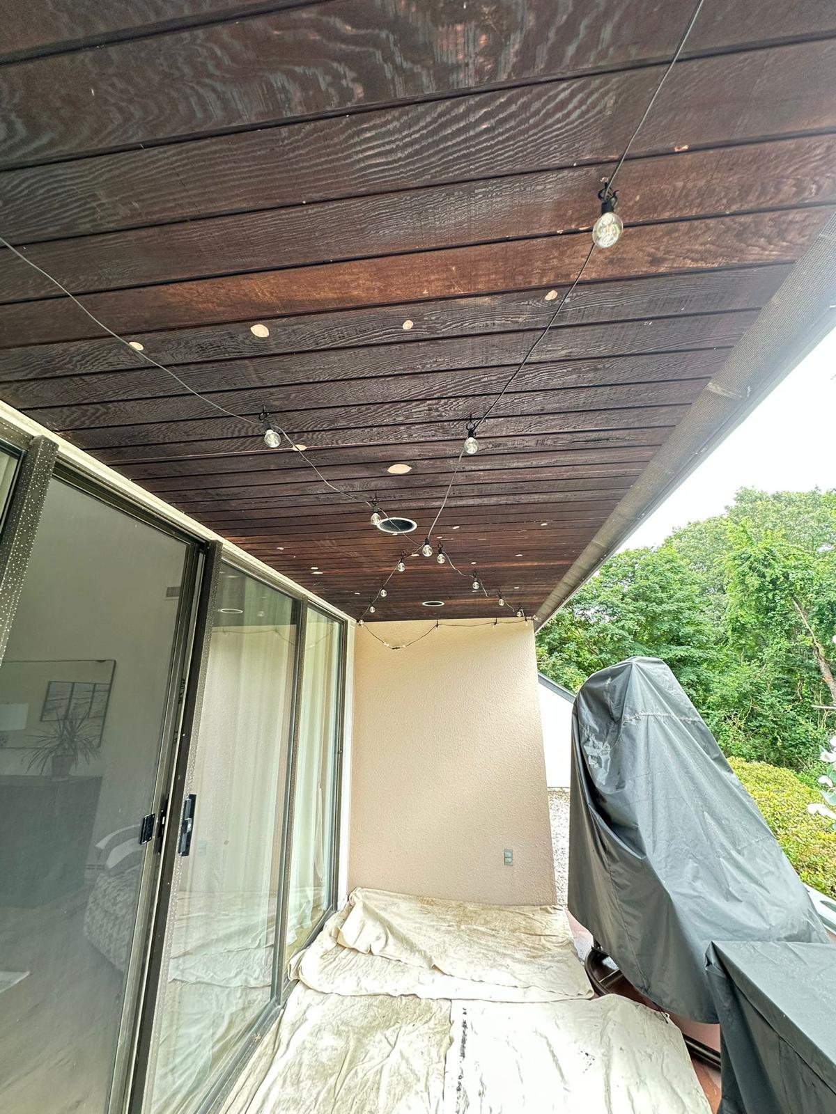 Professional exterior painting team preparing and painting a home's siding