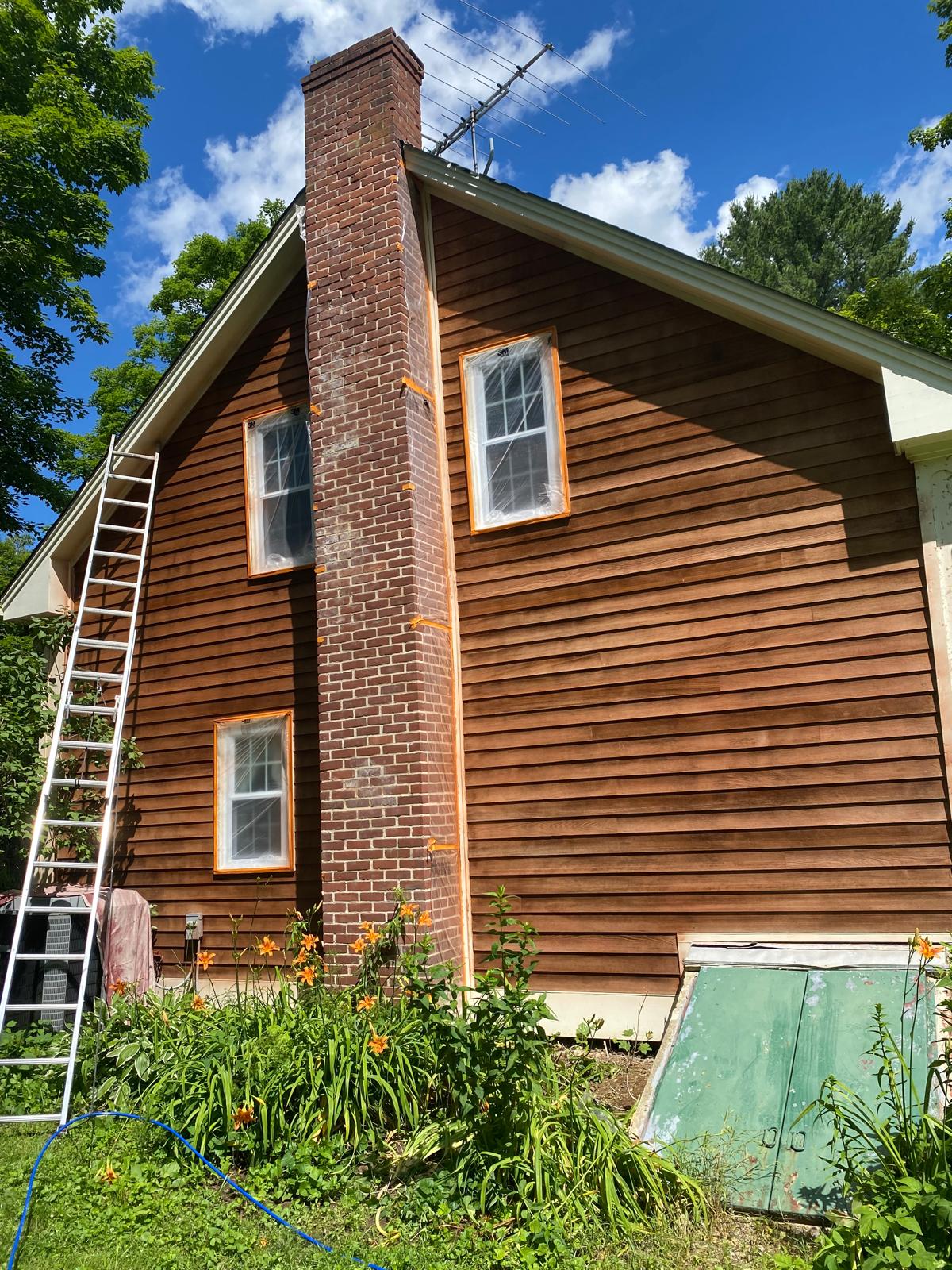 Fence staining project with uniform natural wood tone